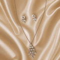 Cascade Teardrop CZ set draped on champagne silk fabric