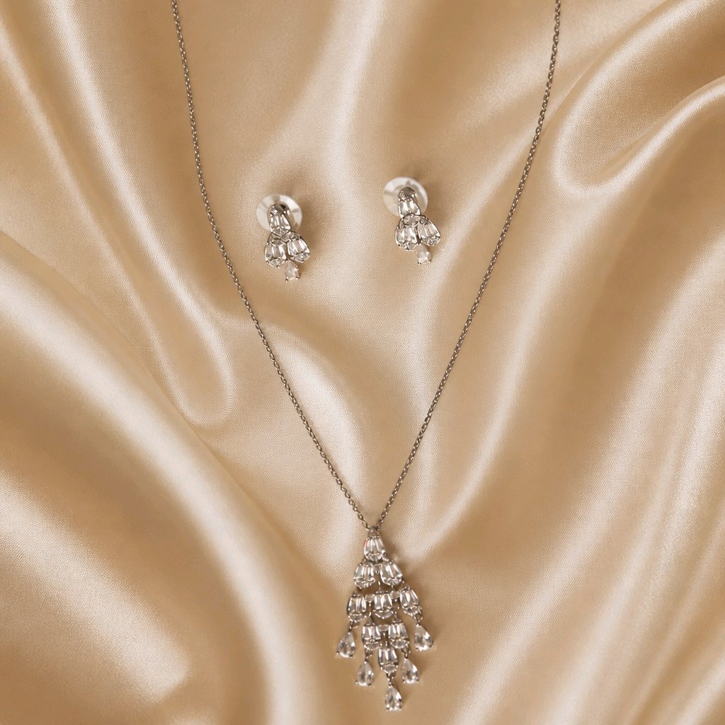 Cascade Teardrop CZ set draped on champagne silk fabric