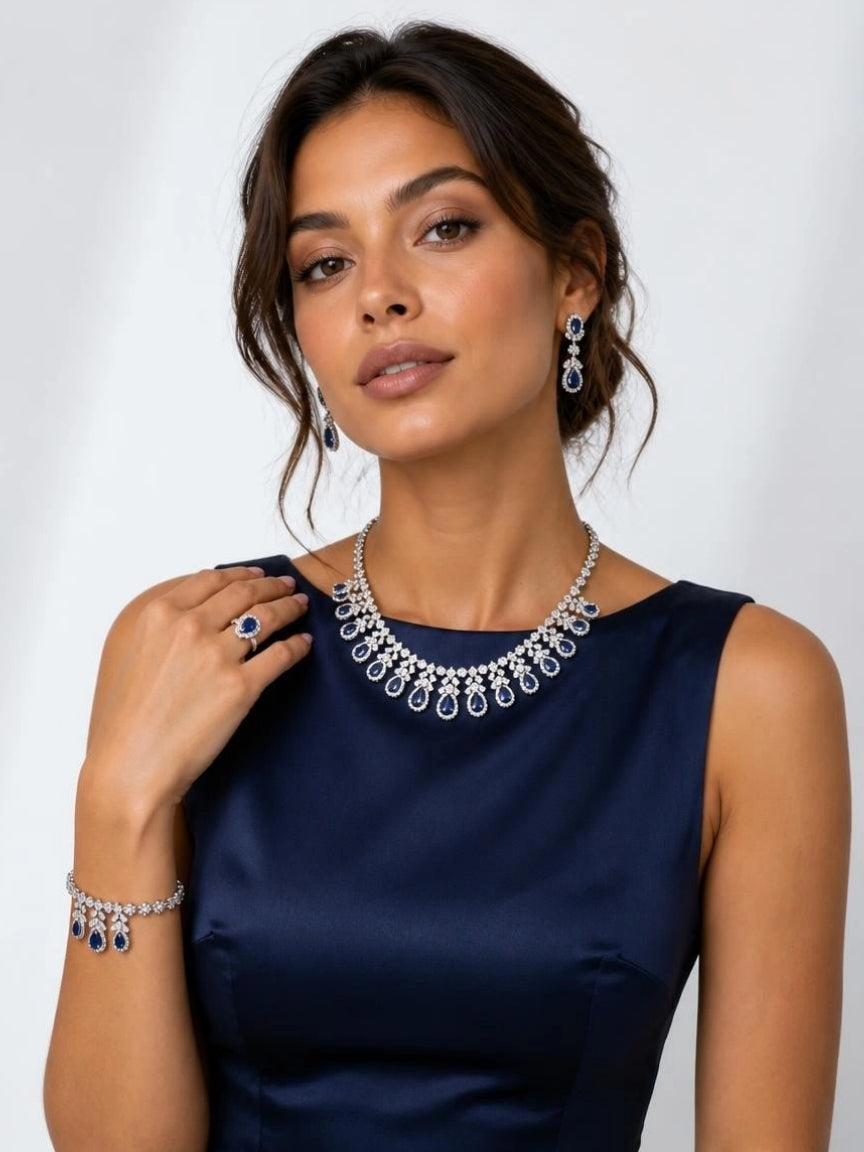Model wearing the Blue Teardrop Elegance 4-piece bridal CZ jewelry set with navy dress