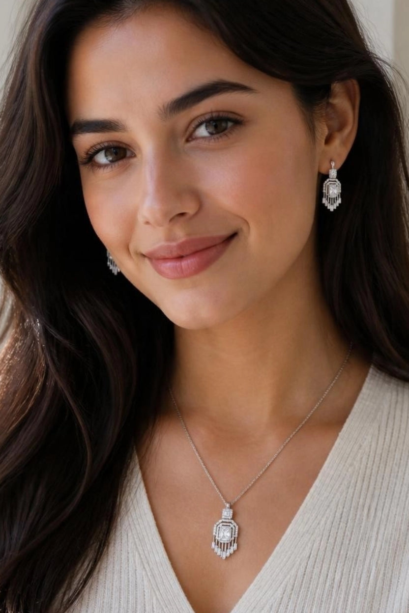 Model wearing Gatsby Fringe CZ necklace and earrings with cream knit top