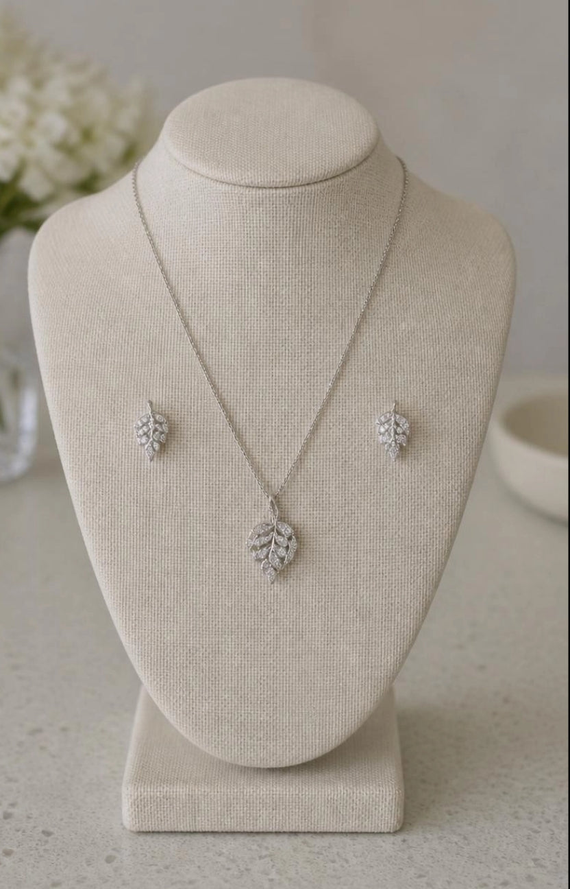 Marquise Leaf CZ necklace and earring set on linen jewelry bust with white flowers in background