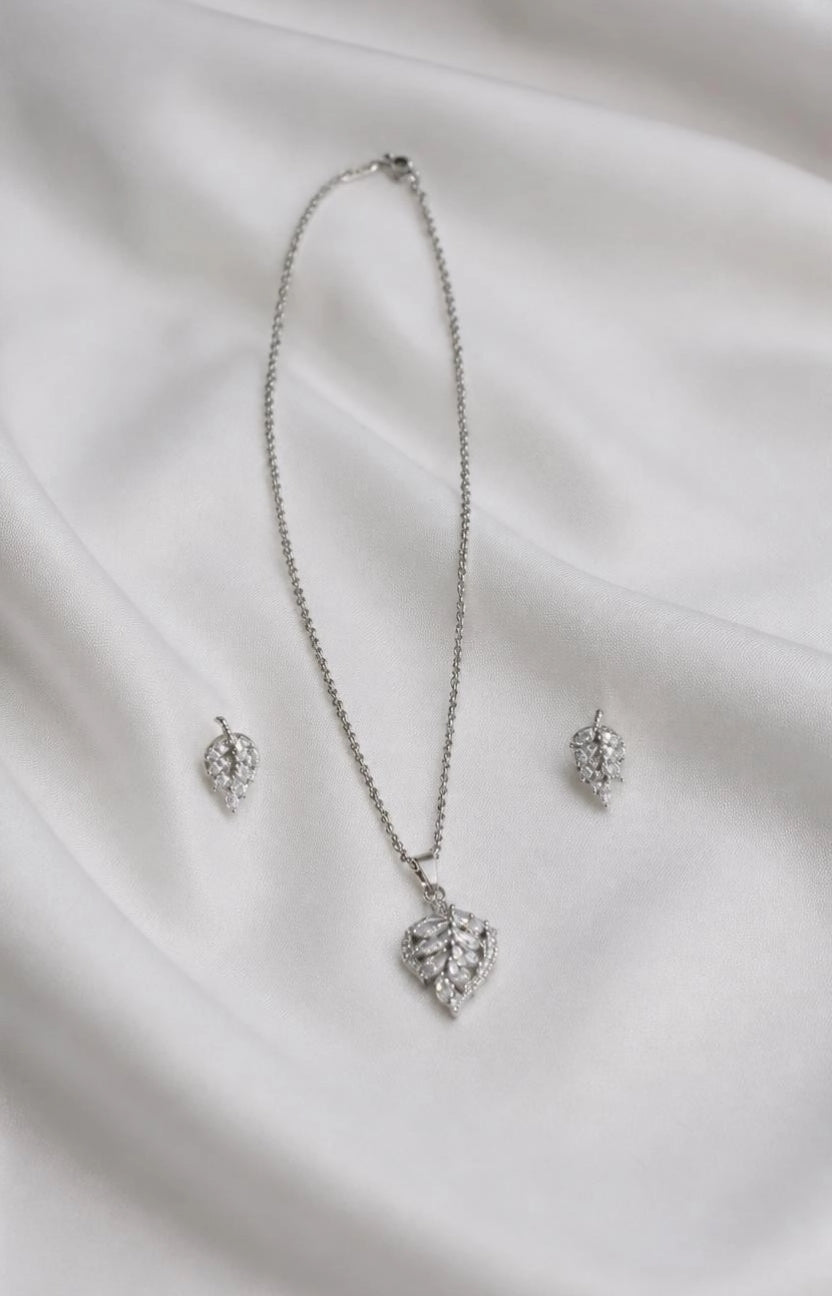 Marquise Leaf CZ necklace and earring set flat lay on white silk fabric