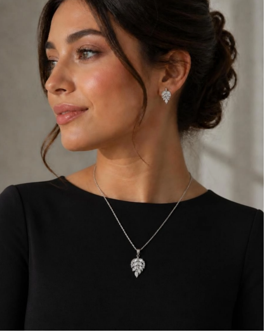 Model wearing Marquise Leaf CZ necklace and earrings with black top and updo hairstyle
