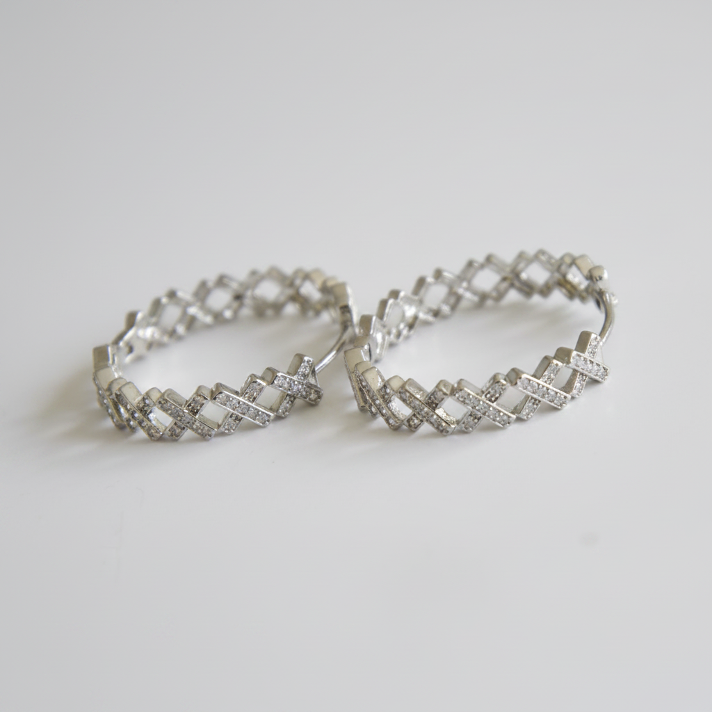 Cubic zirconia lattice hoop earrings close-up on white background