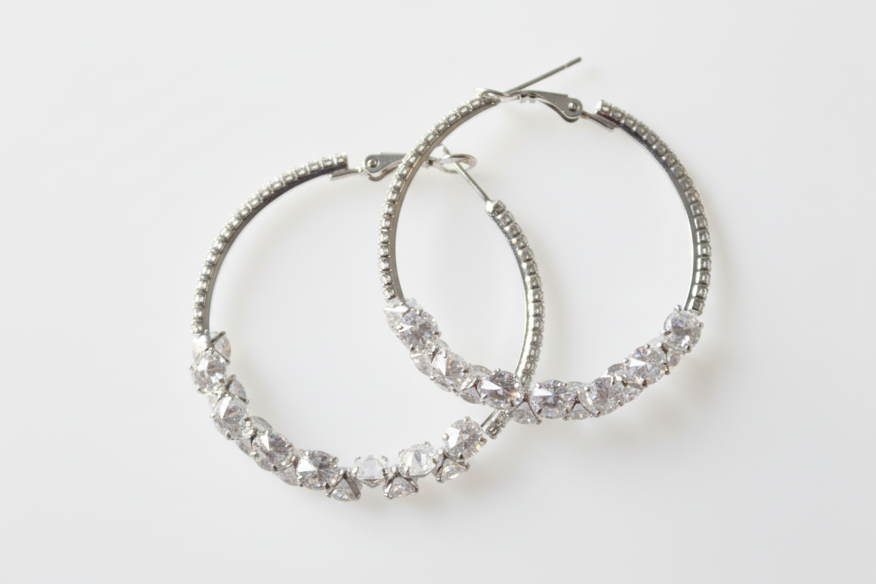 Cubic zirconia cluster hoop earrings on white background