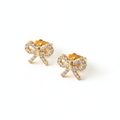 Cubic zirconia bow stud earrings in gold-tone angle view on white background